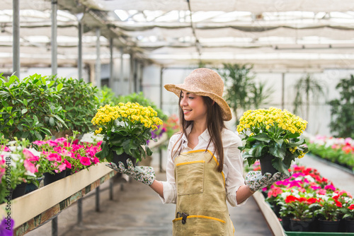 Beautiful woman working in a greenhouse © oneinchpunch