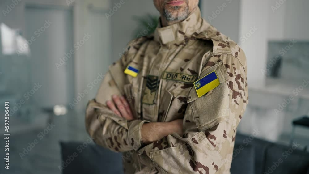 A Ukrainian soldier in camouflage with gray hair looks at the camera. Distance of the camera, review of the form of Ukrainian veins A Ukrainian soldier in camouflage with gray hair looks at the camera. Distance of the camera, review of the form of Ukrainian veins
