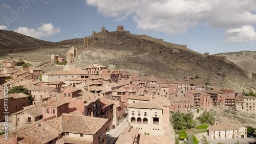 Backward low fly-by over Albarracin Medieval village and its red-roofed houses, Teruel Province, Spain photo
