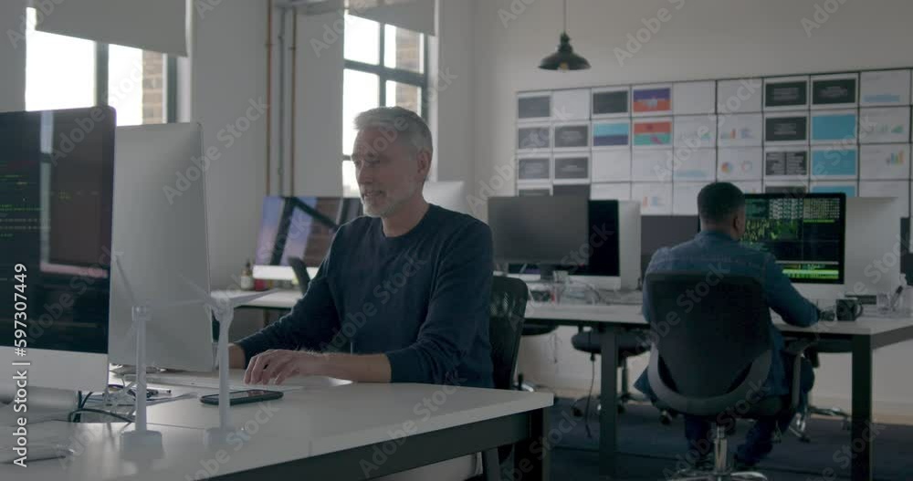 Senior Businessman Working in an Office on Desktop PC Senior Businessman Working in an Office on Desktop PC