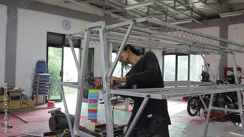 Creative Asian Young People who are Inventing Clotheslines with Kalvalum Iron photo