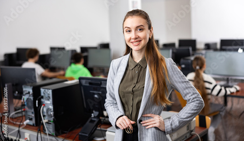 Portrait of a young smiling female computer class teacher at school