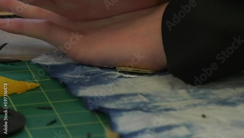 Paint being applied to material using a stamp
