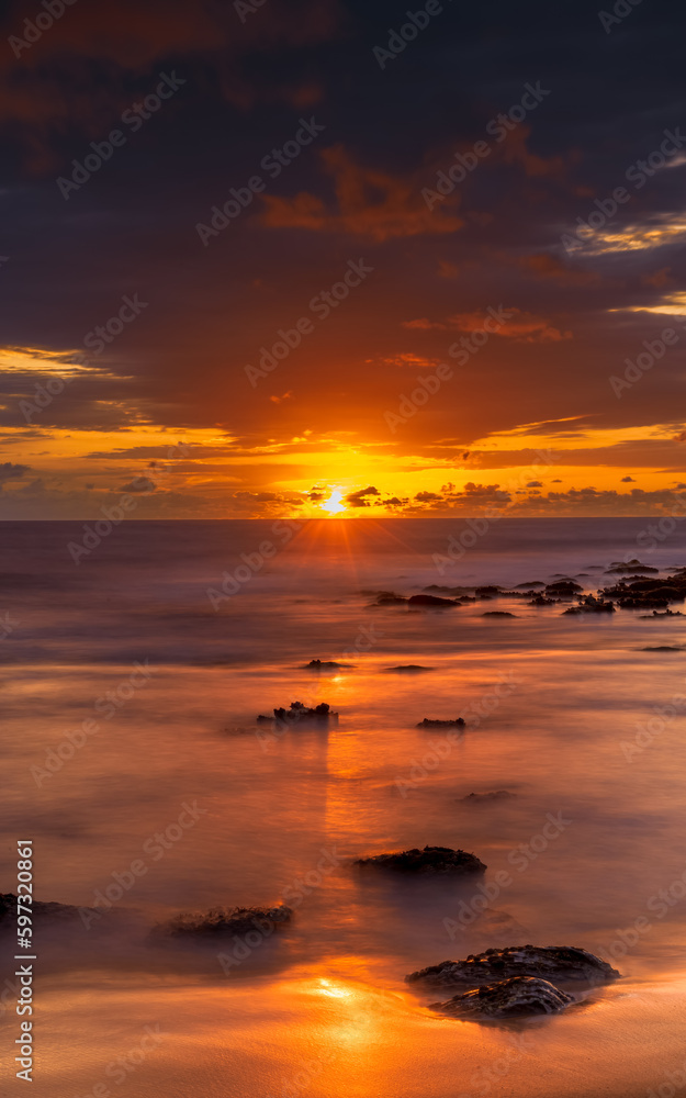 Sunrise with scattered rain clouds at the seaside Sunrise with scattered rain clouds at the seaside