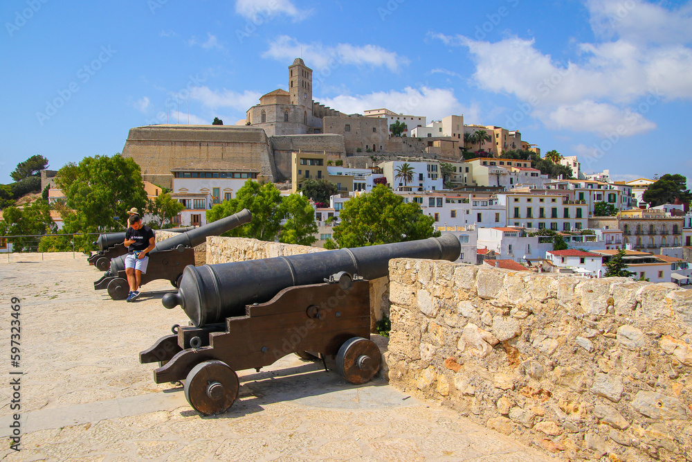 Canons on the terrace of a bastion offering a view on Dalt Vila, the old city center of Ibiza in the Balearic Islands, Spain - Medieval fortress with whitewashed houses in the Mediterranean Sea