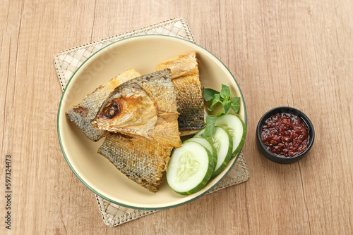 Bandeng Presto or Milkfish with high pressure cooked, served with chilli sauce (sambal), Indonesian food
 photo