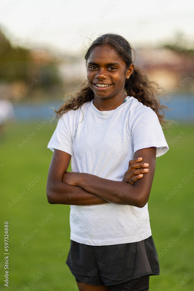 one aboriginal girl standing with arms crossed and looking at the camera one aboriginal girl standing with arms crossed and looking at the camera