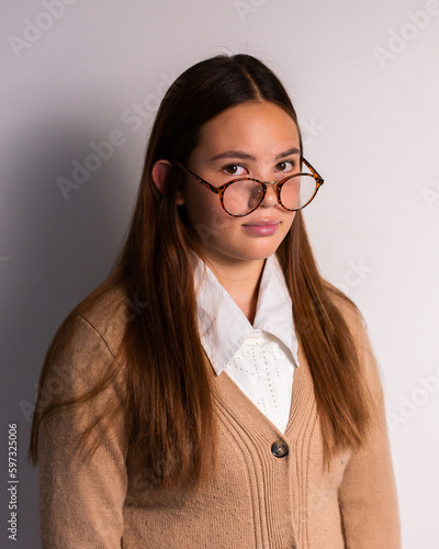 sky teen girl wearing a cardigan and glasses photo