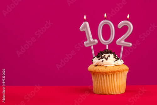 Birthday cake with candle number 102 - Rhodamine Red foamy background