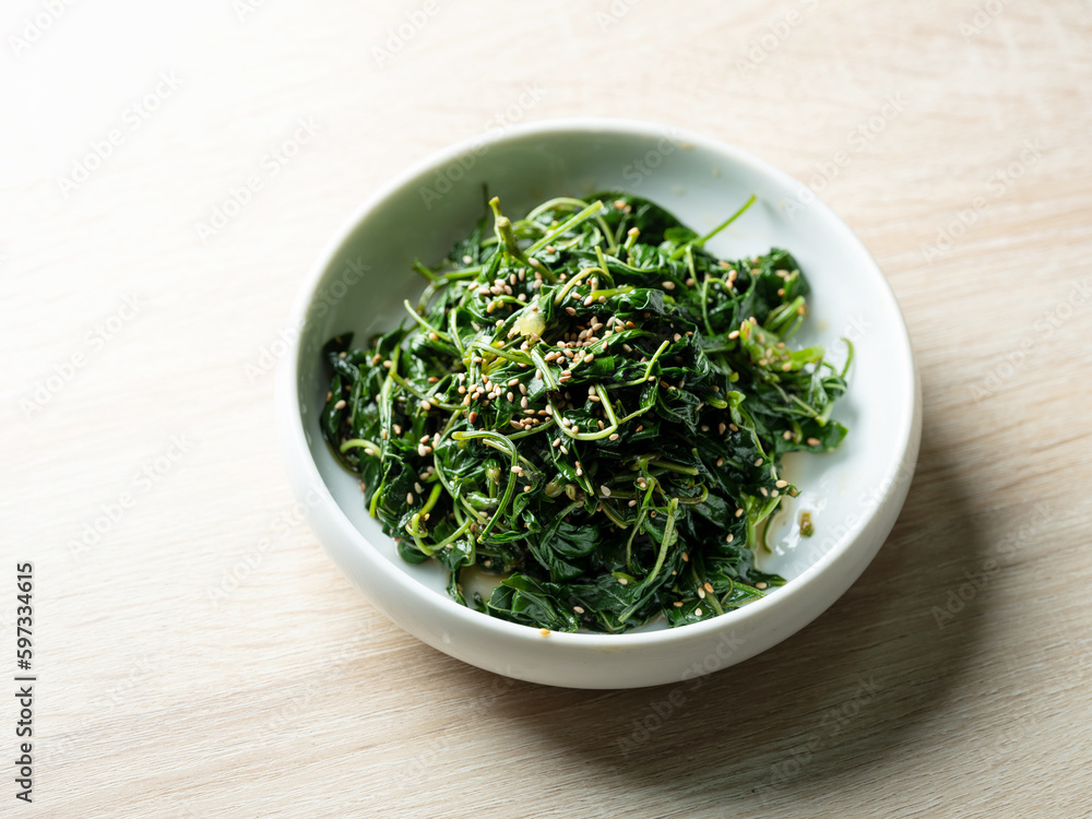Seasoned greens on a plate, side dish Seasoned greens on a plate, side dish
