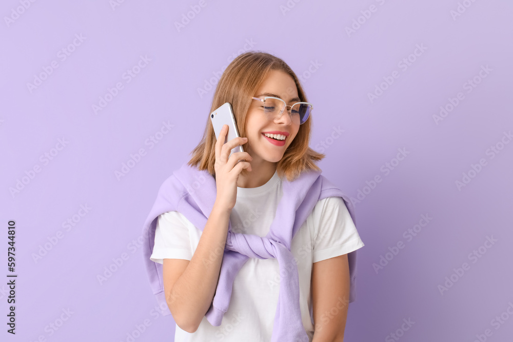 Young woman in eyeglasses talking by mobile phone on lilac background Young woman in eyeglasses talking by mobile phone on lilac background