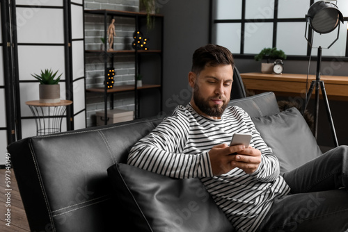 Young bearded man using mob...