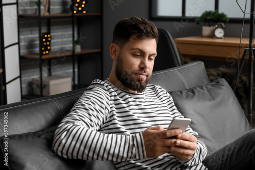 Young bearded man using mob...
