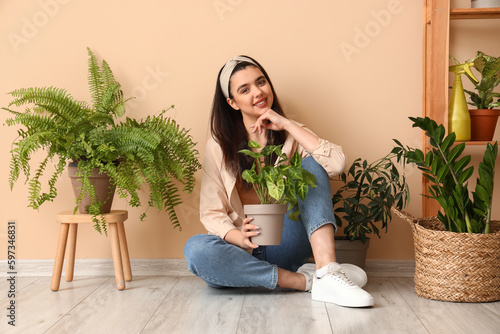 Young woman with green hous...