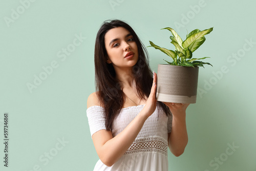 Young woman with houseplant...
