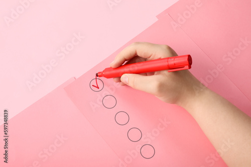 Woman marking on checklist ...