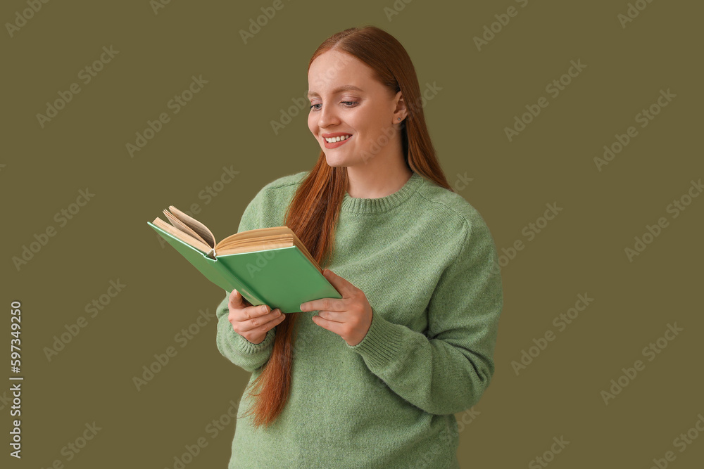 Young woman reading book on green background Young woman reading book on green background