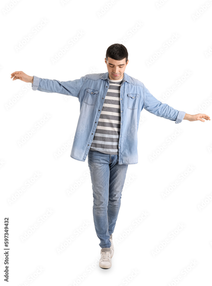 Young man balancing on white background Young man balancing on white background
