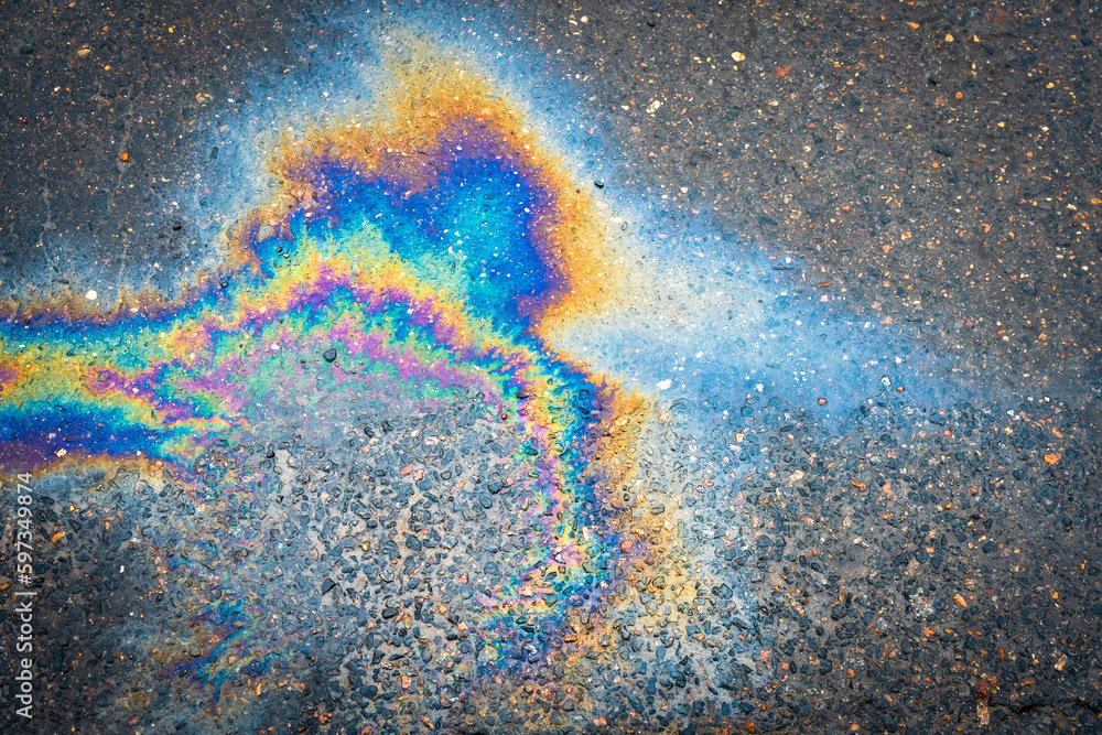 Gasoline oil spill on the pavement as a texture or background ...