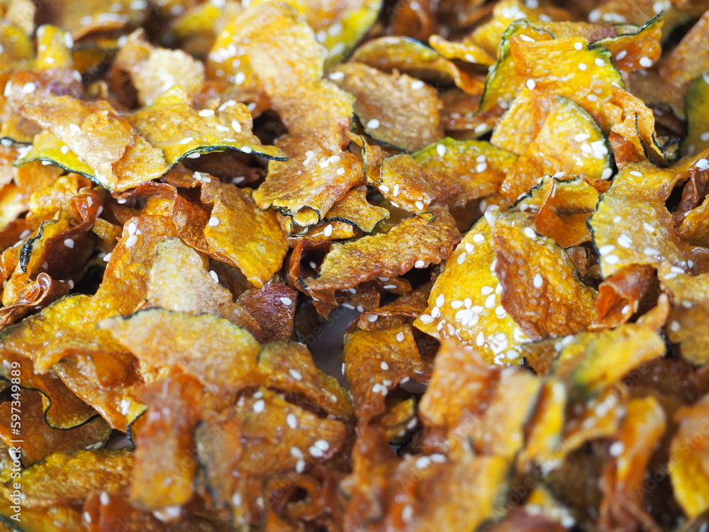 Fried Pumpkin Snacks.Pumpkin slice chips in wooden plate.Closeup topview of fried pumpkin crisp. Fried Pumpkin Snacks.Pumpkin slice chips in wooden plate.Closeup topview of fried pumpkin crisp.