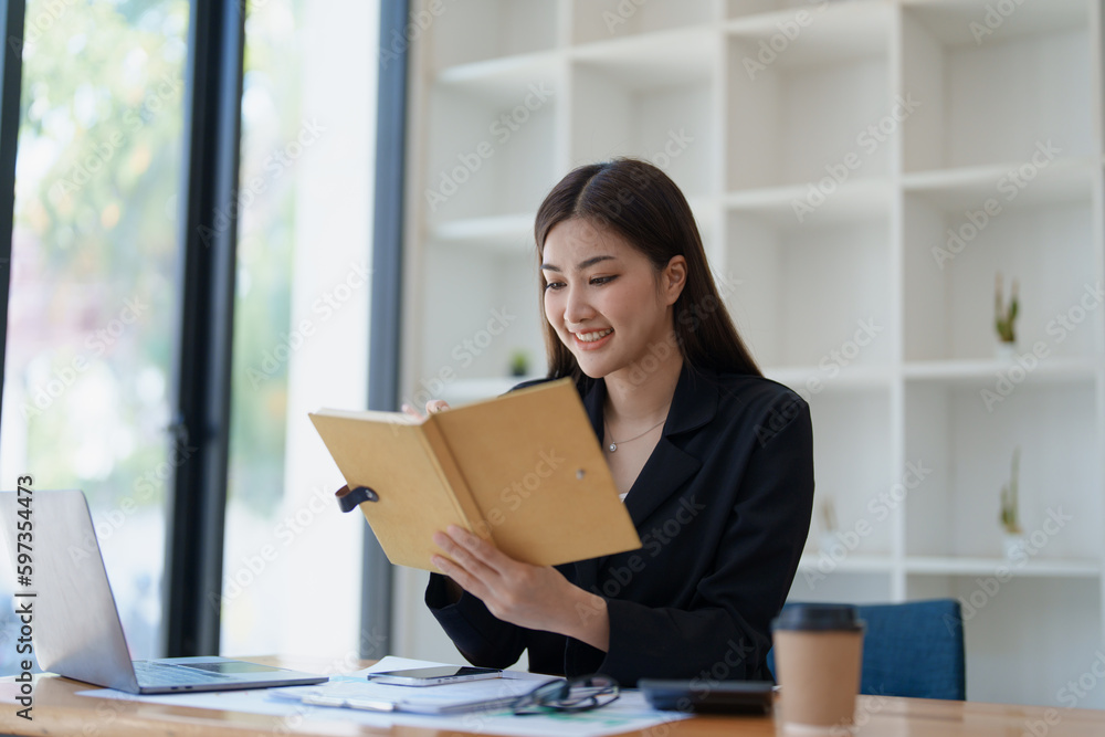 Business planning, portrait of a business woman using a computer to audit financial statements and marketing Business planning, portrait of a business woman using a computer to audit financial statements and marketing