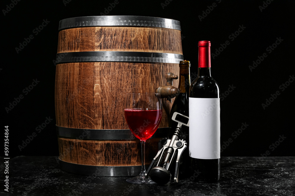 Wooden barrel with bottles and glass of wine on dark background