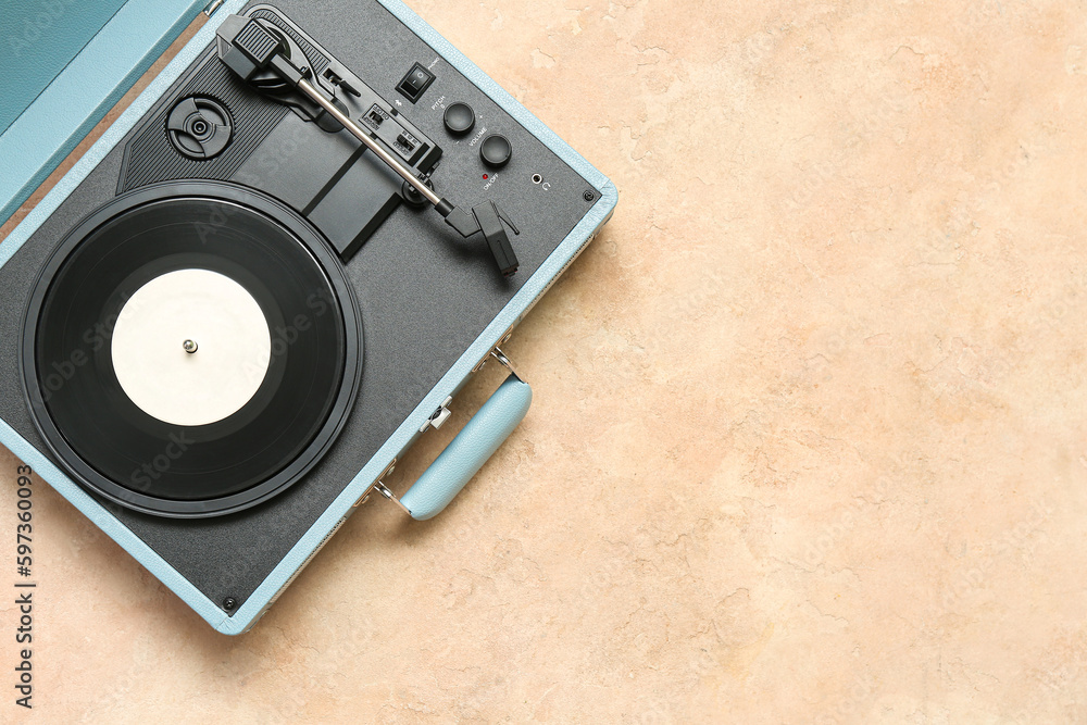 Fototapeta premium Record player with vinyl disk on beige background