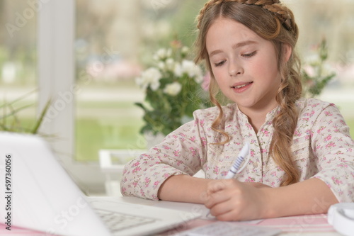 beautiful young girl with laptop studying