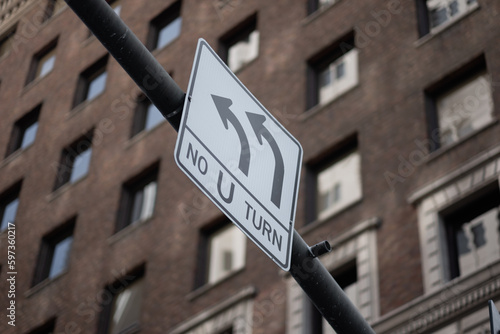 A sign banning u-turns in a high-rise downtown area of San Francisco.