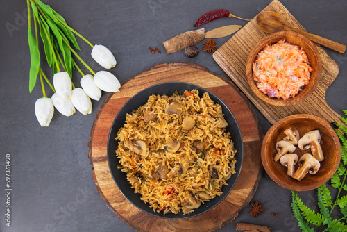 Tasty Mushroom or Mashroom Rice or Pulav or Pilaf or Pulao or Biryani served in bowl or plate. Delicious Mushroom fried rice with isolated background. Also called Kaalan Biryani...