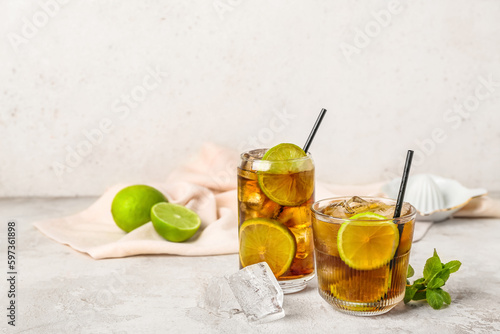 Photography Glasses of tasty Cuba Libre cocktail on light background