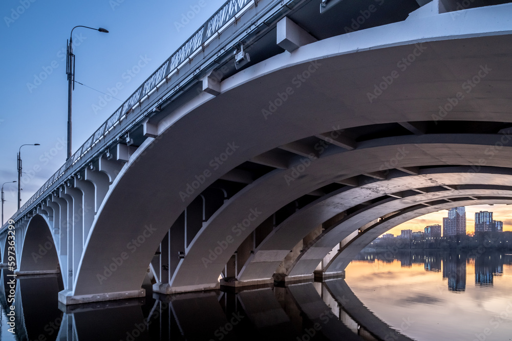 Supports of the bridge over the river made of reinforced concrete close-up.