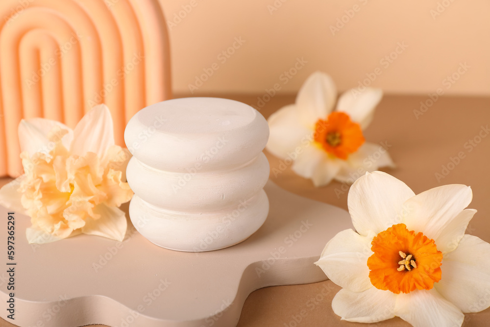 Decorative plaster podiums with flowers on beige background Decorative plaster podiums with flowers on beige background