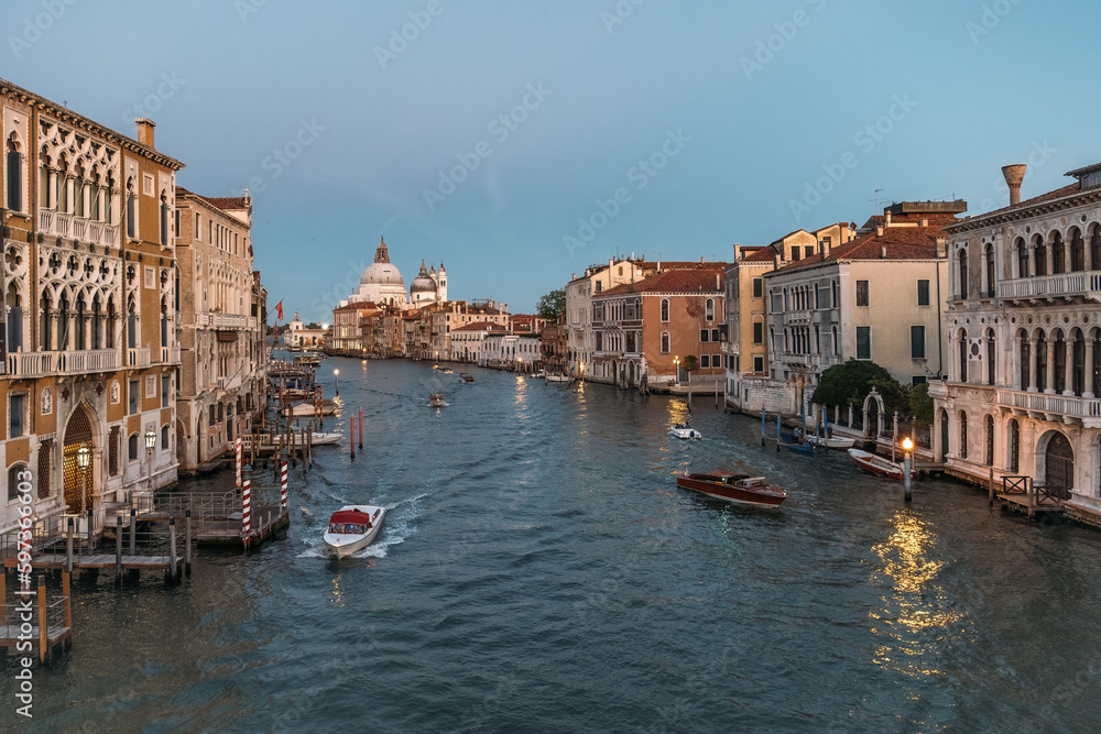 Stunning panoramic view from above on the Grand Canal in Venice on a cloudless warm summer evening. The concept of a honeymoon romantic trip in Europe. Copyspace