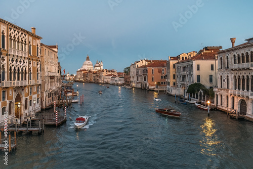 Stunning panoramic view from above on the Grand Canal in Venice on a cloudless warm summer evening. The concept of a honeymoon romantic trip in Europe. Copyspace