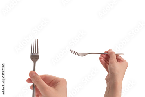 Fork in woman hand isolated on white. © Nikolay