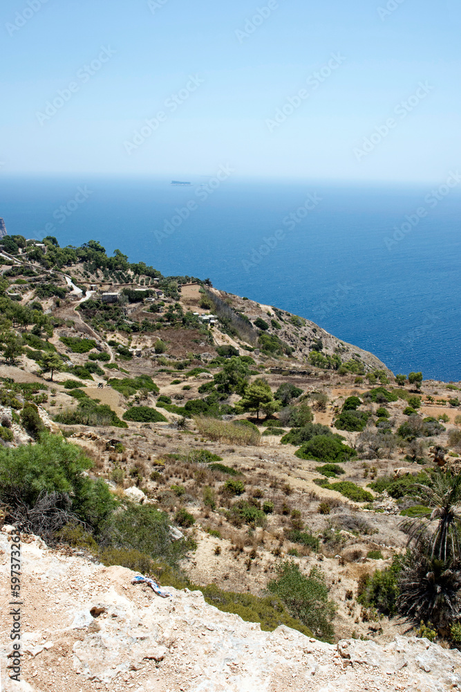 Rock and beautiful scenic view over Malta island with Mediterranean Sea in the background on a hot summer day. Photo taken August 8th, 2017, Blue Grotto, Malta. Rock and beautiful scenic view over Malta island with Mediterranean Sea in the background on a hot summer day. Photo taken August 8th, 2017, Blue Grotto, Malta.
