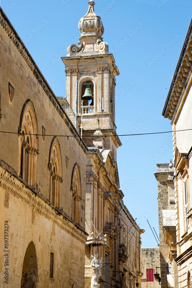 City of Mdina, former capital of Malta, with clock tower of Chapel of St. Roque also know as Chapel of Our Lady of Light on a hot summer day. Photo taken August 8th, 2017, Mdina, Malta.