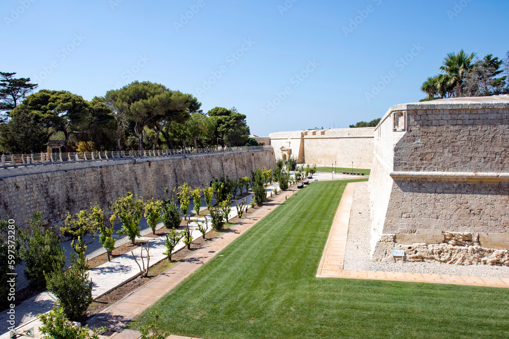 City wall with moat at City of Mdina, former capital of Malta, on a hot summer day. Photo taken August 8th, 2017, Valletta, Malta.