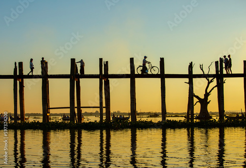 Amarapura  Myanmar - November 22  2016  Unidentified people walk on U Bein bridge at sunset in Myanmar. U Bein bridge is the longest teak bridge in the world.