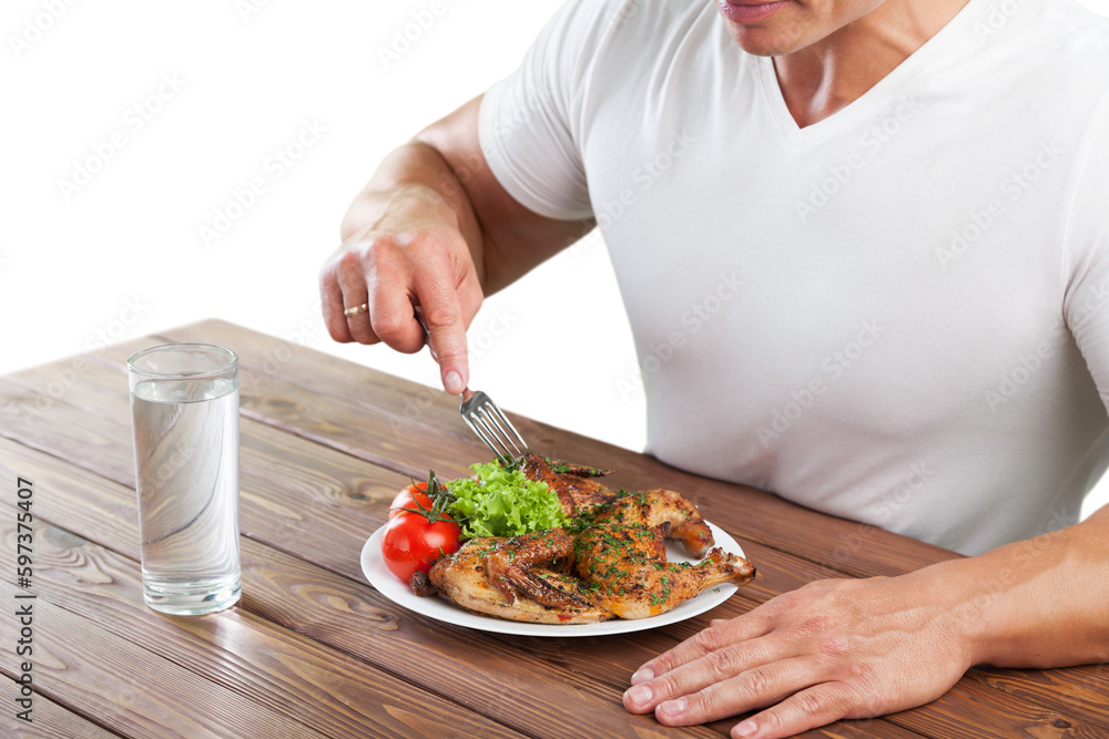 Male hands with meat and vegetables on wooden desk