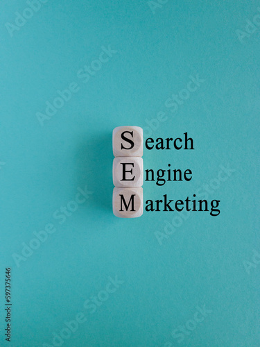 SEM search engine marketing symbol. Wooden cubes with words 'SEM search engine marketing' on beautiful blue background, copy space. Business, SEM search engine marketing concept.