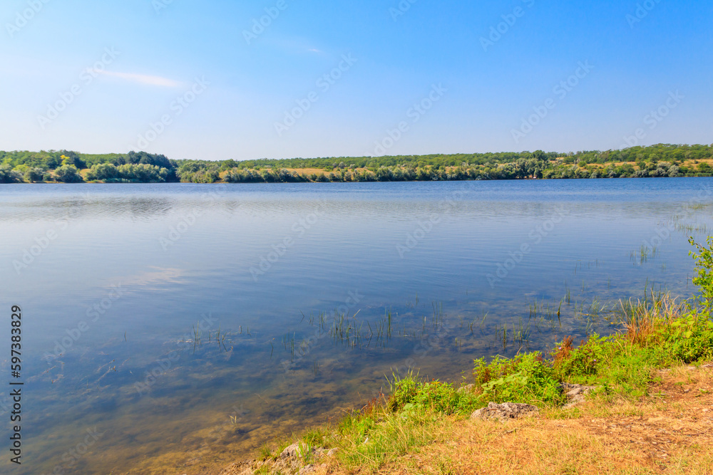 Summer landscape with beautiful river, green trees and blue sky Summer landscape with beautiful river, green trees and blue sky