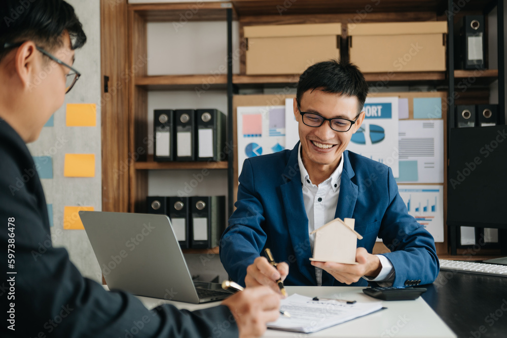 Salesman Hands On House Model , Small Toy House Small Mortgage Property insurance and concepts real estate..