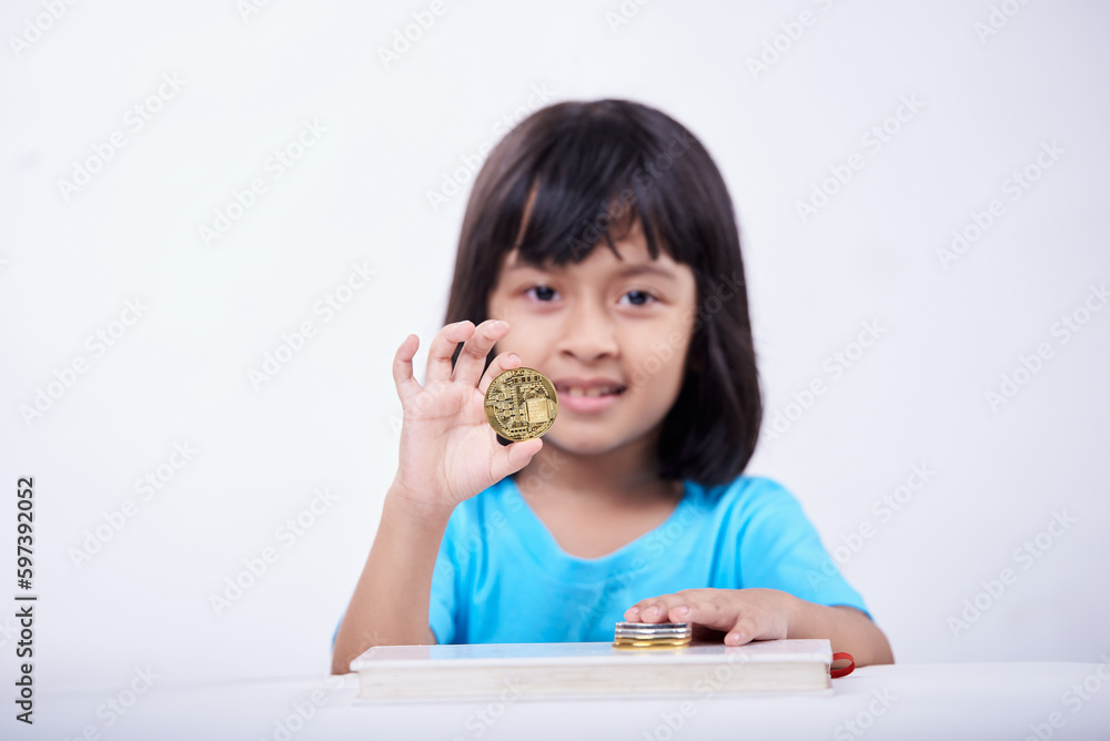 Little girl playing and learning with Cryptocurrency coins Little girl playing and learning with Cryptocurrency coins