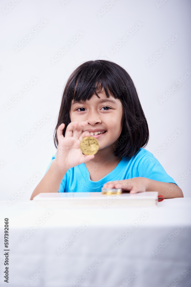 Little girl playing and learning with Cryptocurrency coins Little girl playing and learning with Cryptocurrency coins