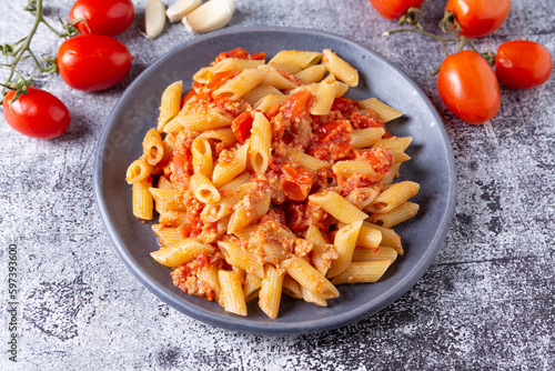 Pennette with tuna and cherry tomatoes. Typical dish of traditional Italian and Mediterranean cuisine. Healthy and balanced dish suitable for both lunch and dinner.