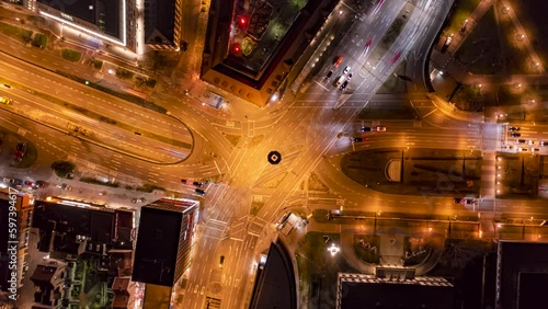 Time lapse zoom out cars speeding through illuminated intersection at night, Stuttgart 
