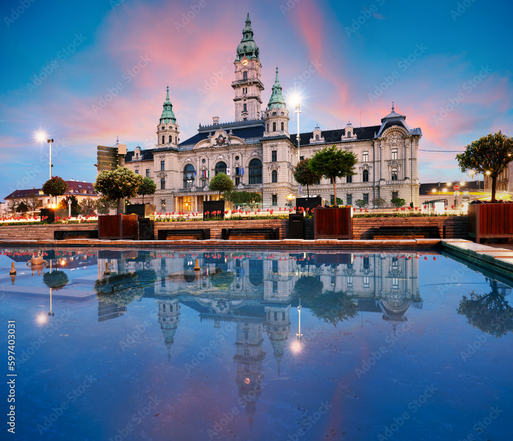 Gyor Town hall at night with reflection in water, Hungary