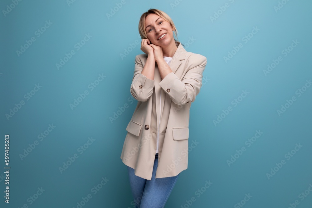 cheerful blonde young woman in jacket on studio background with copy space cheerful blonde young woman in jacket on studio background with copy space